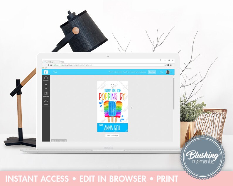 May include: A laptop displays a printable tag design with a popsicle graphic. The tag reads "THANK YOU FOR POPPING BY" and includes the name "Anna Bell." The design features rainbow colors and is on a white background.