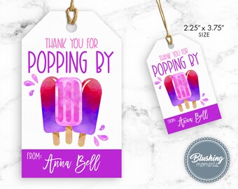 May include: Thank you for popping by favor tag with a purple background and three watercolor popsicles. The text "Thank you for popping by" is in purple and the text "From: Anna Bell" is in gold. The tag measures 2.25 inches by 3.75 inches.