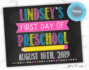 May include: A chalkboard sign with the text "LINDSEY'S FIRST DAY OF PRESCHOOL AUGUST 10TH, 2019" in colorful, handwritten font. A yellow pencil with a pink eraser is drawn on the sign.