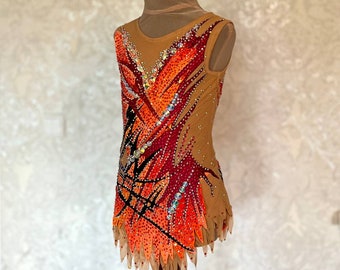 May include: A sleeveless leotard with a brown base and a colorful design featuring orange, red, and black accents. The leotard is decorated with rhinestones and has a jagged hemline.