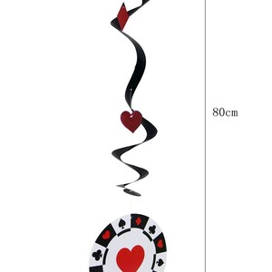 May include: A black and red poker-themed hanging decoration. The decoration is 80cm long and features a swirling black ribbon with red card suit symbols and a poker chip with a red heart in the center, measuring 18cm in diameter.