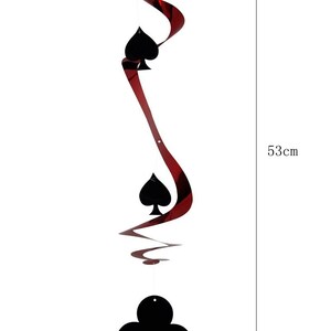 May include: A decorative hanging swirl with a red and black design, featuring black spade and club suit symbols. The swirl is approximately 53cm long and the club symbol is 10cm wide.
