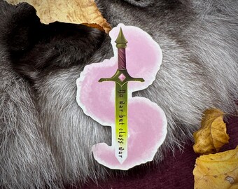 May include: A sticker featuring a stylized sword with a green blade and a burgundy handle. The text "No war but class war" is written vertically on the blade. The sticker is on a pink background, with a fur-like texture in the background.