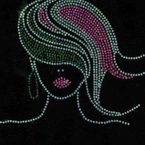 May include: A black background with a rhinestone design of a woman's face with green and pink hair. The rhinestones are arranged in a pattern that creates the illusion of hair.