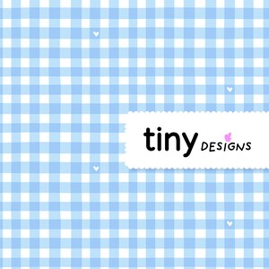 May include: A light blue and white gingham pattern background with small white hearts scattered throughout. A white rectangular label with the words "tiny designs" in black and pink script is in the lower right corner.