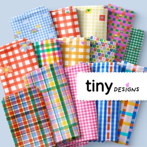 May include: A selection of patterned pouches in a variety of colours. Designs include gingham, plaid, and floral patterns in red, blue, yellow, and pink. The text "tiny designs" is displayed on a white label.