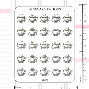 May include: A sheet of 24 black and white teacup stickers with a steaming cup of tea and a tea bag. The stickers are on a white background with a ruler in inches and centimeters.