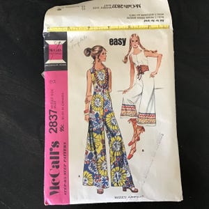 May include: Vintage McCall's 2837 Misses' Jumpsuit sewing pattern. The pattern features illustrations of two jumpsuits, one with a floral print and the other with a solid white design. The pattern is marked "easy" and includes sizes 12 and 34.