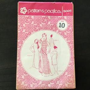 May include: A rectangular sewing pattern envelope by Patterns Pacifica, number 3007, size 10. The pink and white packaging features a repeating floral pattern and a central circular illustration showing three dress variations labeled View A, B, and C.