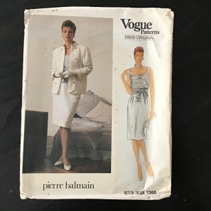 May include: Vogue Patterns Paris Original sewing pattern featuring a Pierre Balmain design. The pattern includes illustrations of a white suit and a striped top with a skirt. The pattern number is 1360.