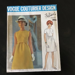 May include: Vintage Vogue Couturier Design sewing pattern featuring a yellow sleeveless dress with a matching jacket. The pattern includes a design by Fabiani of Italy, with a model wearing a hat and gloves. The pattern number is 2065.