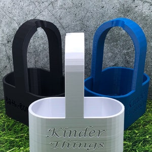 May include: Three 3D printed beverage holders, one black, one white, and one blue. The white holder has the text "Kinder Things" engraved on the side.