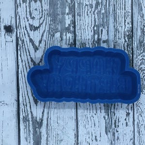 May include: Blue plastic cookie cutter shaped like a banner with the text "Happy Birthday" in a bubbly font.