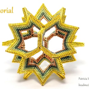 May include: A multi-faceted, geometric beadwork sculpture with a starburst shape. The sculpture is made with small, iridescent beads in shades of gold, green, and copper. The sculpture is on a white background.