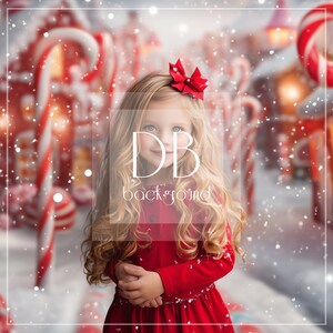 May include: A young girl with long blonde hair wearing a red dress and a red bow in her hair. She is standing in front of a snowy background with candy cane decorations.