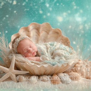 May include: A newborn baby peacefully sleeps inside a large seashell, nestled in soft, cream-colored fabric. The baby wears a delicate headband and a light blue and cream-colored wrap. A starfish and seashells are in the foreground, with a teal background.