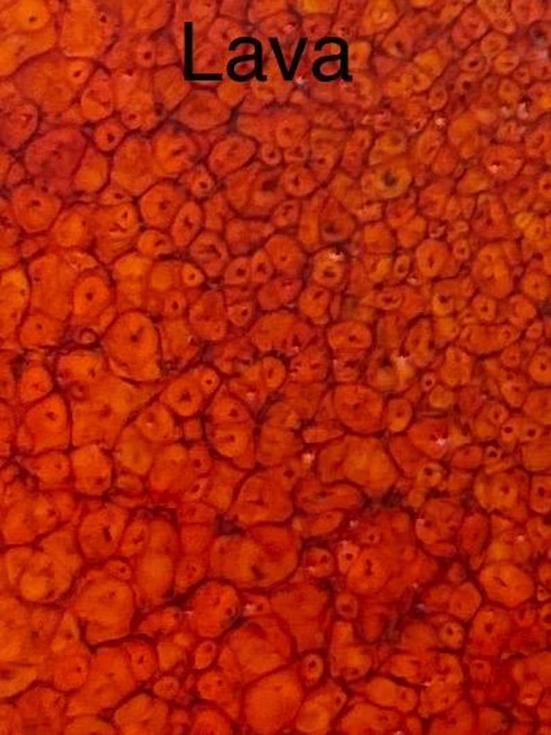 A close-up of a glaze sample labeled "Lava," featuring a textured, bubbly surface in shades of orange and red.
