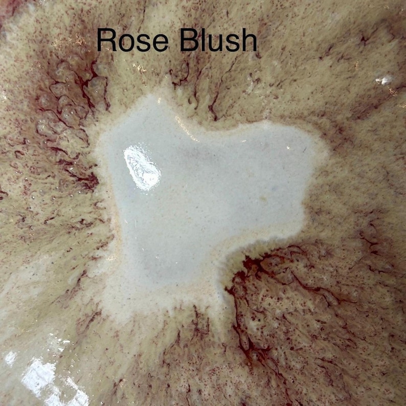 Close-up of a ceramic surface with a light cream center and radiating dark red and pink patterns, with the text "Rose Blush" overlaid.