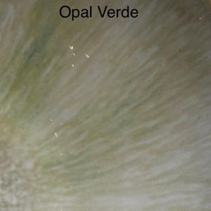A close-up of a glaze sample labeled "Opal Verde," showing a light green, slightly iridescent surface with faint white streaks.