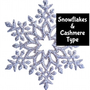 May include: A large, silver glitter snowflake decoration with intricate details. The snowflake has a six-pointed star shape with multiple smaller points. Text on a black background reads "Snowflakes & Cashmere Type".