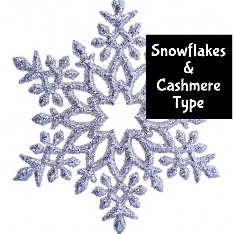 May include: A large, silver glitter snowflake decoration with intricate details. The snowflake has a six-pointed star shape with multiple smaller points. Text on a black background reads "Snowflakes & Cashmere Type".