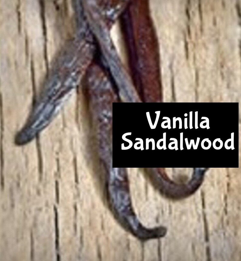 May include: Close-up of dried vanilla beans with a black label that reads "Vanilla Sandalwood".