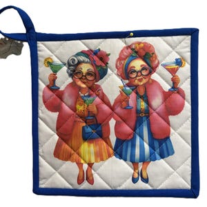 May include: Quilted pot holder with a blue trim and hanging loop. The image features two elderly women in pink coats and hats, holding cocktails. The women are wearing glasses and dresses. The background is white with a diamond pattern.
