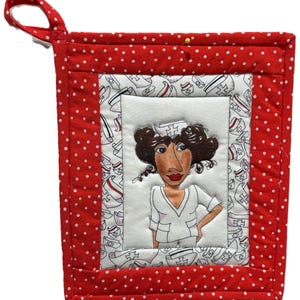 May include: A red and white polka dot pot holder with a hanging loop. The centre features a cartoon illustration of a nurse in a white uniform. The border is red with white polka dots.