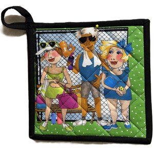 May include: Quilted pot holder with a black border and a green polka dot backing. The front features a cartoon illustration of three people in athletic attire, with a chain-link fence background. The pot holder has a black loop for hanging.