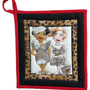 May include: Square quilted potholder with a red border and a loop for hanging. The center features an illustration of two women in dresses, with a leopard print and black border.