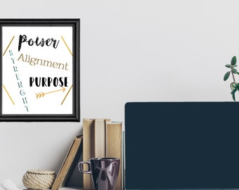 May include: A black framed print with a white background and gold accents. The print features the words "Power", "Alignment", and "Purpose" in black text. The word "Strength" is written vertically in blue text. An arrow points to the right.