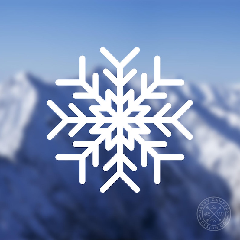 May include: A white snowflake design against a blurred background of blue and white mountains.