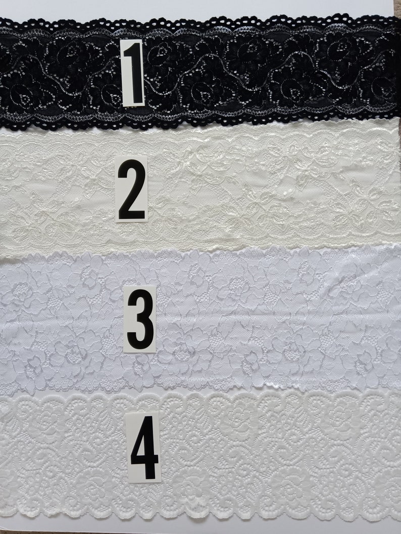 May include: Four samples of lace trim, numbered 1 through 4. The first sample is black lace, the remaining three are white lace.