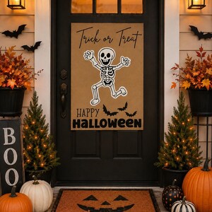 May include: A rectangular tan sign hanging on a black door featuring the text Trick or Treat at the top, a central illustration of a dancing white skeleton, and the text HAPPY HALLOWEEN at the bottom with three small black bat silhouettes.