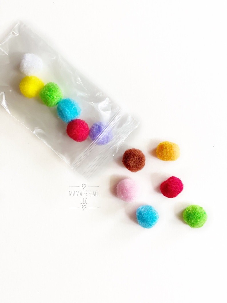May include: A clear plastic bag filled with colorful pom poms. The bag is open and the pom poms are spilling out. The pom poms are in the colors white, yellow, green, blue, red, purple, brown, orange, pink, light blue, and dark green. The bag has the text "Mama's Place LLC" printed on it.