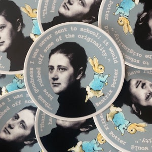 May include: A set of round stickers featuring a black and white portrait of Beatrix Potter, the author of the children's book "The Tale of Peter Rabbit". The stickers also feature an illustration of Peter Rabbit in a blue jacket, hopping along. The text on the stickers reads "I was never sent to school; it would have rubbed off some of the originality." and "Beatrix Potter".