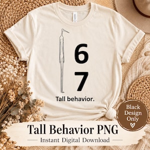May include: A cream-coloured short-sleeve t-shirt featuring a black graphic of a tall, thin, bird-like figure standing next to the large black numbers 6 and 7. Below the graphic, the text reads Tall behaviour. in a simple black sans-serif font.