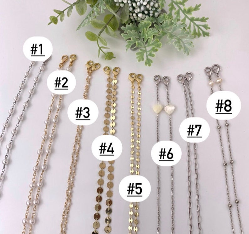 May include: Eight different styles of gold and silver chains with various charms and beads. The chains are numbered 1 through 8.