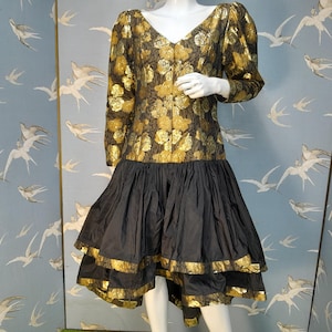 christina stambolian black cocktail dress The black silk 'Revenge Dress' designed by Christina Stambolian. Worn to a summer party hosted by Vanity Fair at the Serpentine Gallery June 1994, the night that Charles admitted adultery in a