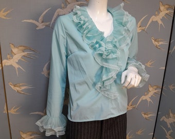 Vintage 1970s pale blue nylon ruffle jabot blouse, ruffle neck sleeve top, size  12- 14 uk/ 40" bust