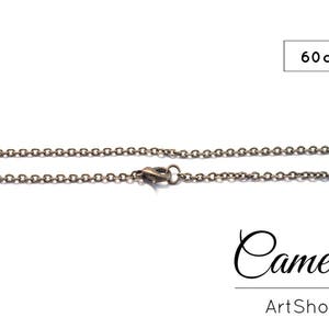 May include: A silver chain necklace with a lobster clasp. The chain is 60 inches long.