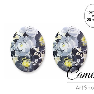 Può includere: Due orecchini rotondi, bianchi, con motivo floreale a design floreale grigio e giallo. Gli orecchini misurano 18 mm x 25 mm.