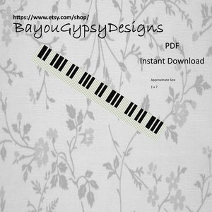 May include: A black and white piano keyboard pattern, with the text "Bayou Gypsy Designs" and "PDF Instant Download" above the keyboard. The text "Approximate Size 1 x 7" is below the keyboard.
