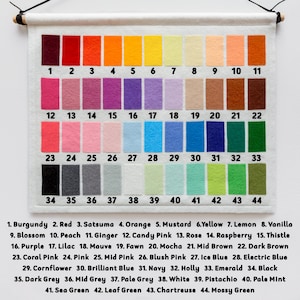 May include: A color chart with 44 different felt swatches, numbered 1 through 44. Each swatch is labeled with a color name, such as Burgundy, Red, Satsuma, Orange, Mustard, Yellow, Lemon, Vanilla, Blossom, Peach, Ginger, Candy Pink, Rose, Raspberry, Thistle, Purple, Lilac, Mauve, Fawn, Mocha, Mid Brown, Dark Brown, Coral Pink, Pink, Mid Pink, Blush Pink, Ice Blue, Electric Blue, Cornflower, Brilliant Blue, Navy, Holly, Emerald, Black, Dark Grey, Mid Grey, Pale Grey, White, Pistachio, Pale Mint, Sea Green, Leaf Green, Chartreuse, and Mossy Green.