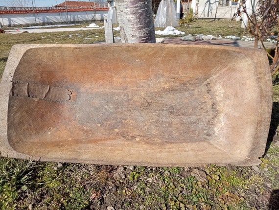 A genuine 19th-century hand-carved antique dough tray at 40 inches — a museum-worthy farmhouse artifact that doubles as dramatic living room decor.
