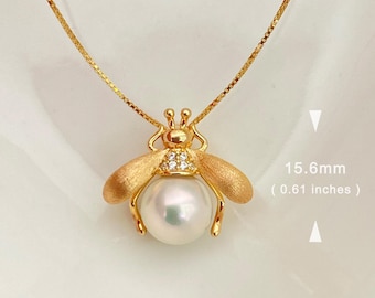 May include: A gold necklace with a bee pendant featuring a pearl and clear crystals. The pendant is 15.6 mm (0.61 inches) in diameter. FP-0183