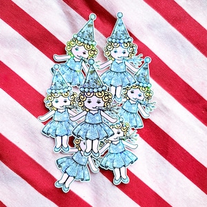 May include: A collection of seven stickers featuring cartoon girls in blue dresses and party hats. Each girl is blowing a party favor. The stickers are on a red and white striped background.
