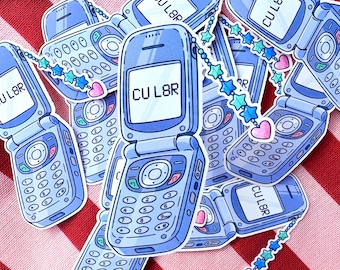 May include: A collection of light blue flip phone stickers with the word "CUL8R" on the screen. The stickers have a cartoon style and are decorated with star and heart charms. The background is a red and white striped fabric.