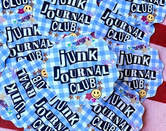 May include: A collection of die-cut stickers with a light blue and white gingham pattern. Each sticker features the text "JUNK JOURNAL CLUB" in a bold, black font, along with decorative elements like stars and smiley faces.