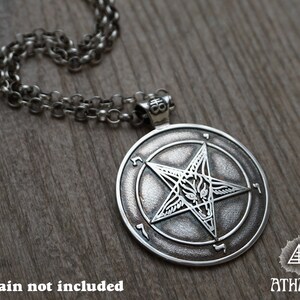 May include: Silver pendant necklace featuring a pentagram with a goat's head inside, surrounded by a circle of Hebrew characters. The pendant is on a silver chain. *Chain not included*